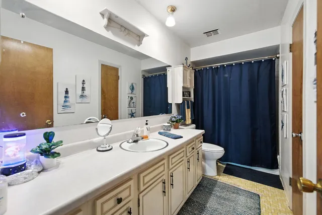 a spacious bathroom with a sink double vanity and a mirror
