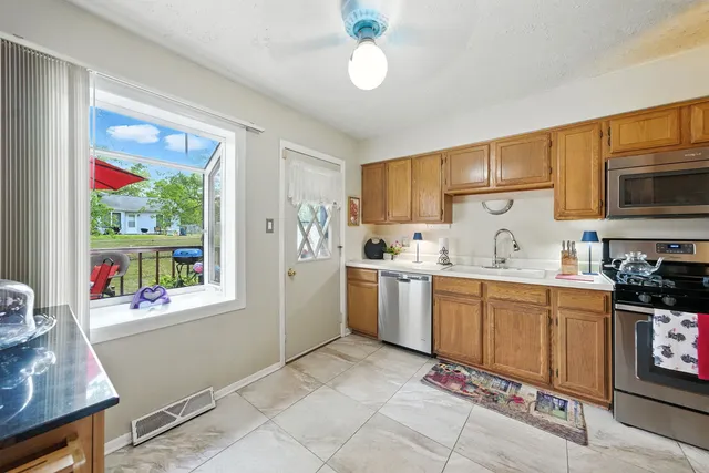 a kitchen with sink cabinets and window