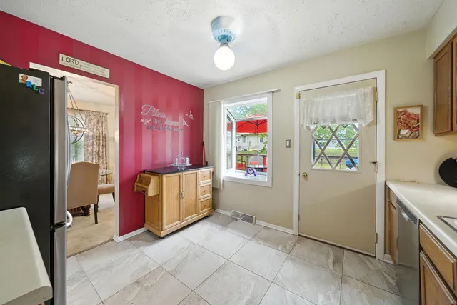 a view of an entryway with furniture and refrigerator