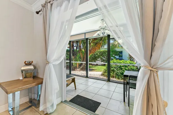 a view of front door and porch with wooden floor