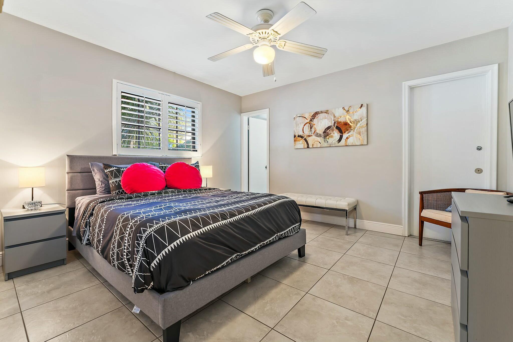 3036 Park Avenue Riviera Beach, FL 33404 - Photo 13 of 22 a bedroom with a bed and a chandelier