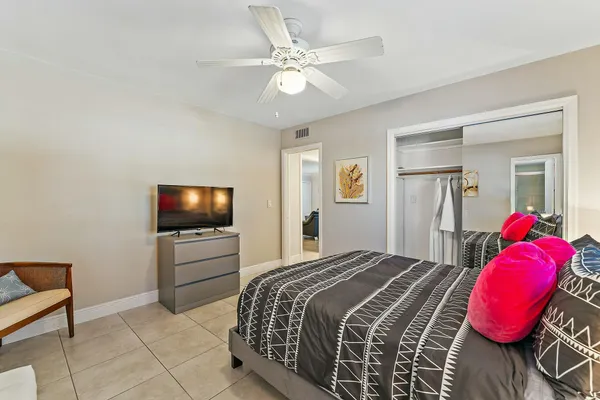 a bedroom with a bed and a television
