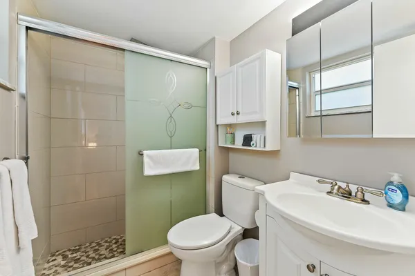a white toilet sitting next to a bathroom sink