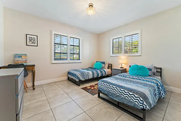 a bedroom with two beds and a window