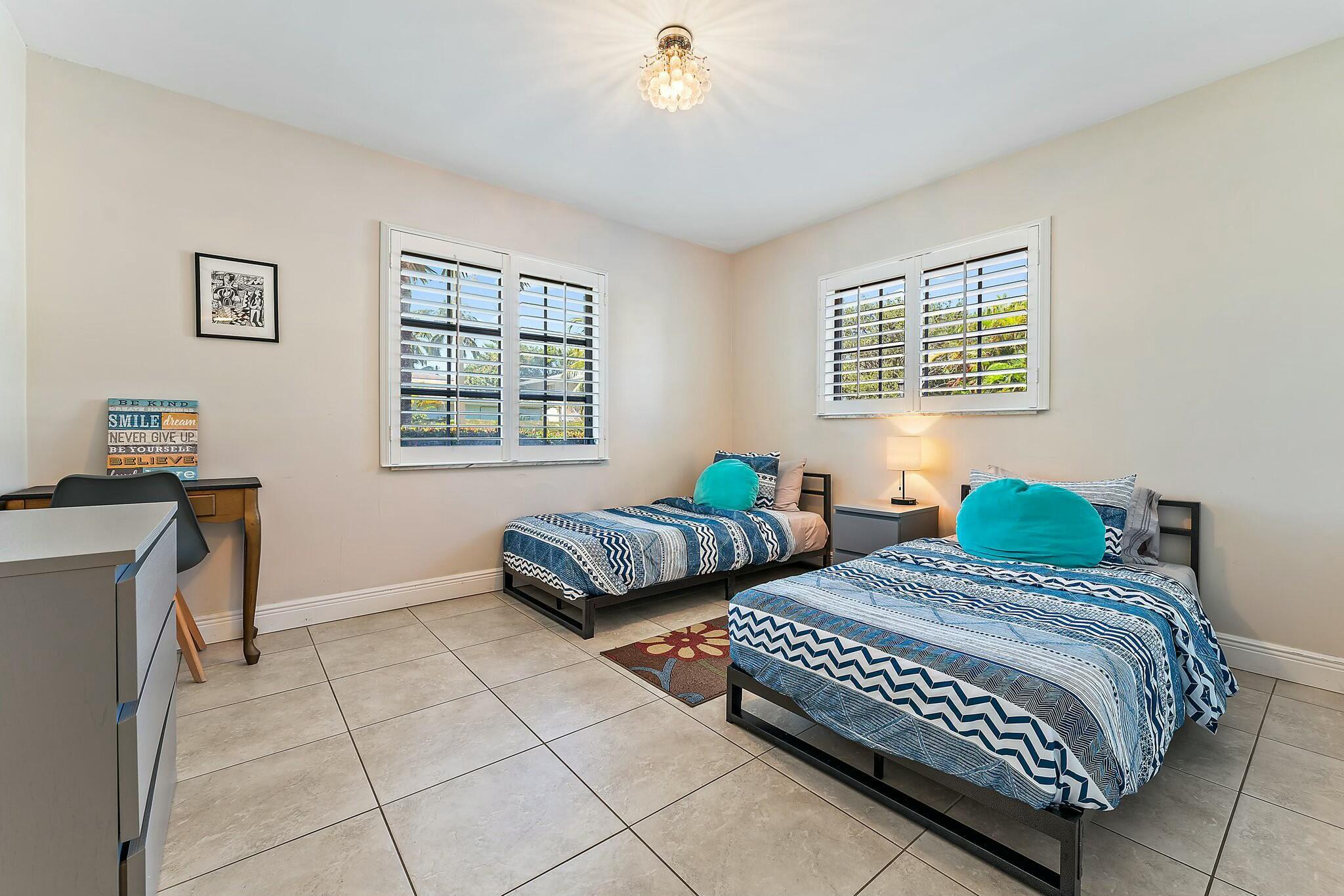 3036 Park Avenue Riviera Beach, FL 33404 - Photo 16 of 22 a bedroom with two beds and a window