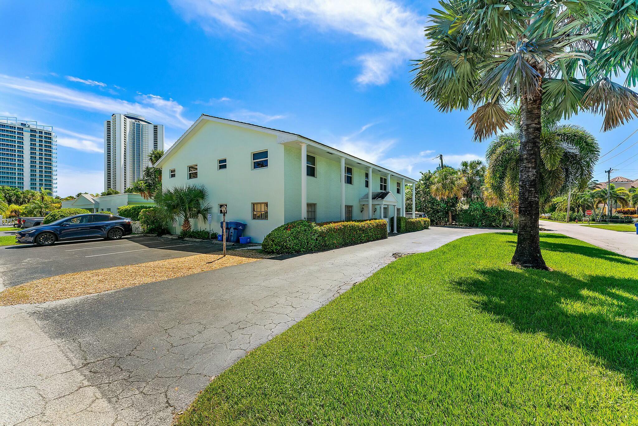 3036 Park Avenue Riviera Beach, FL 33404 - Photo 20 of 22 a front view of a house with a yard and palm trees