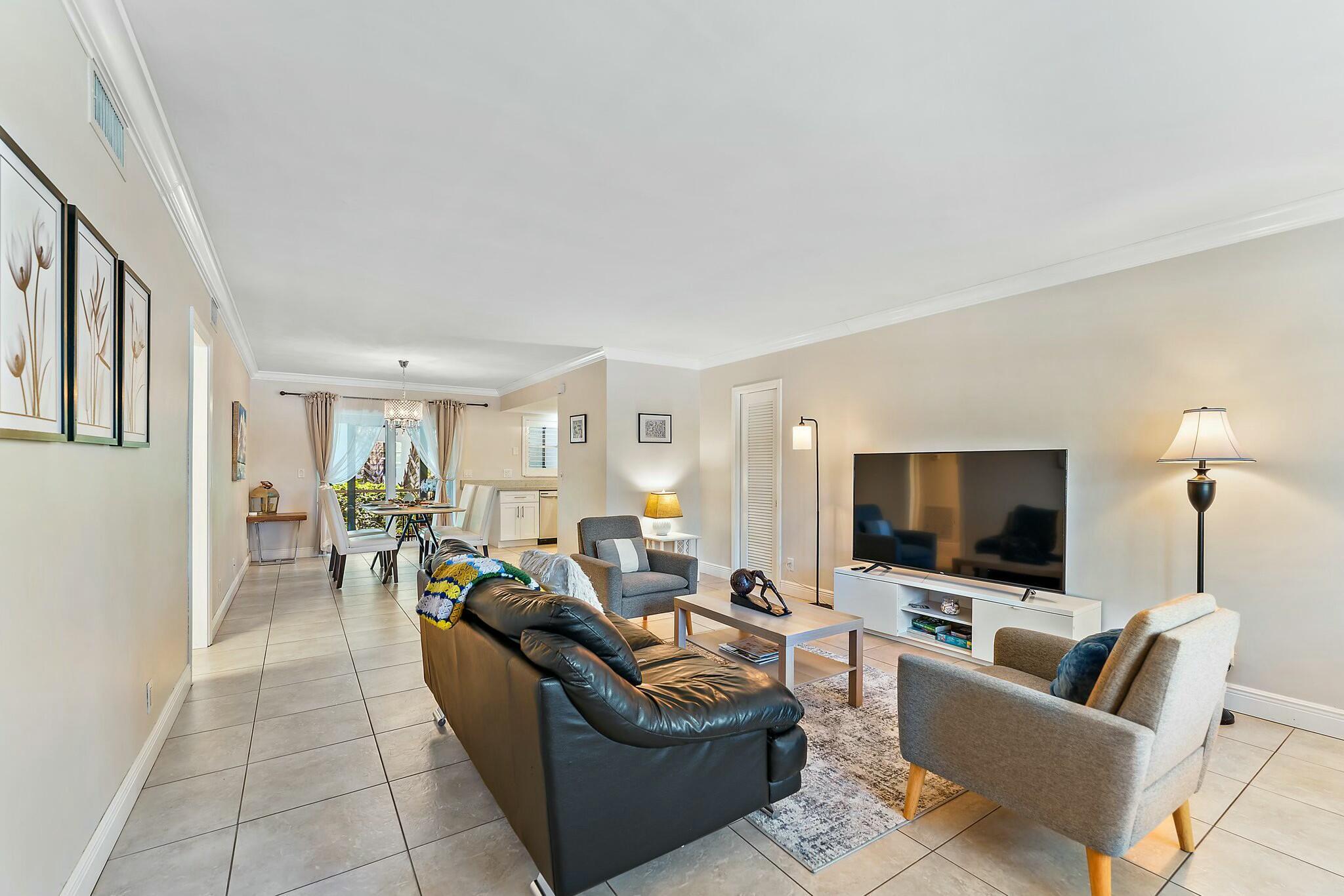 3036 Park Avenue Riviera Beach, FL 33404 - Photo 2 of 22 a living room with furniture and a flat screen tv