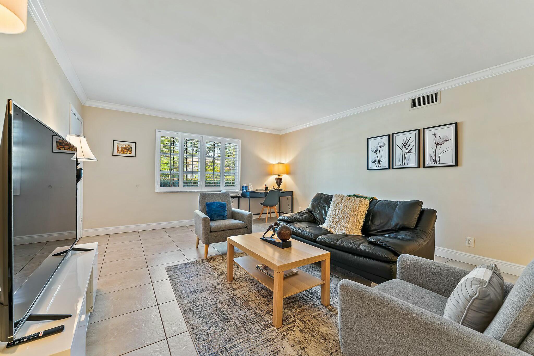 3036 Park Avenue Riviera Beach, FL 33404 - Photo 4 of 22 a living room with furniture a large window and a flat screen tv
