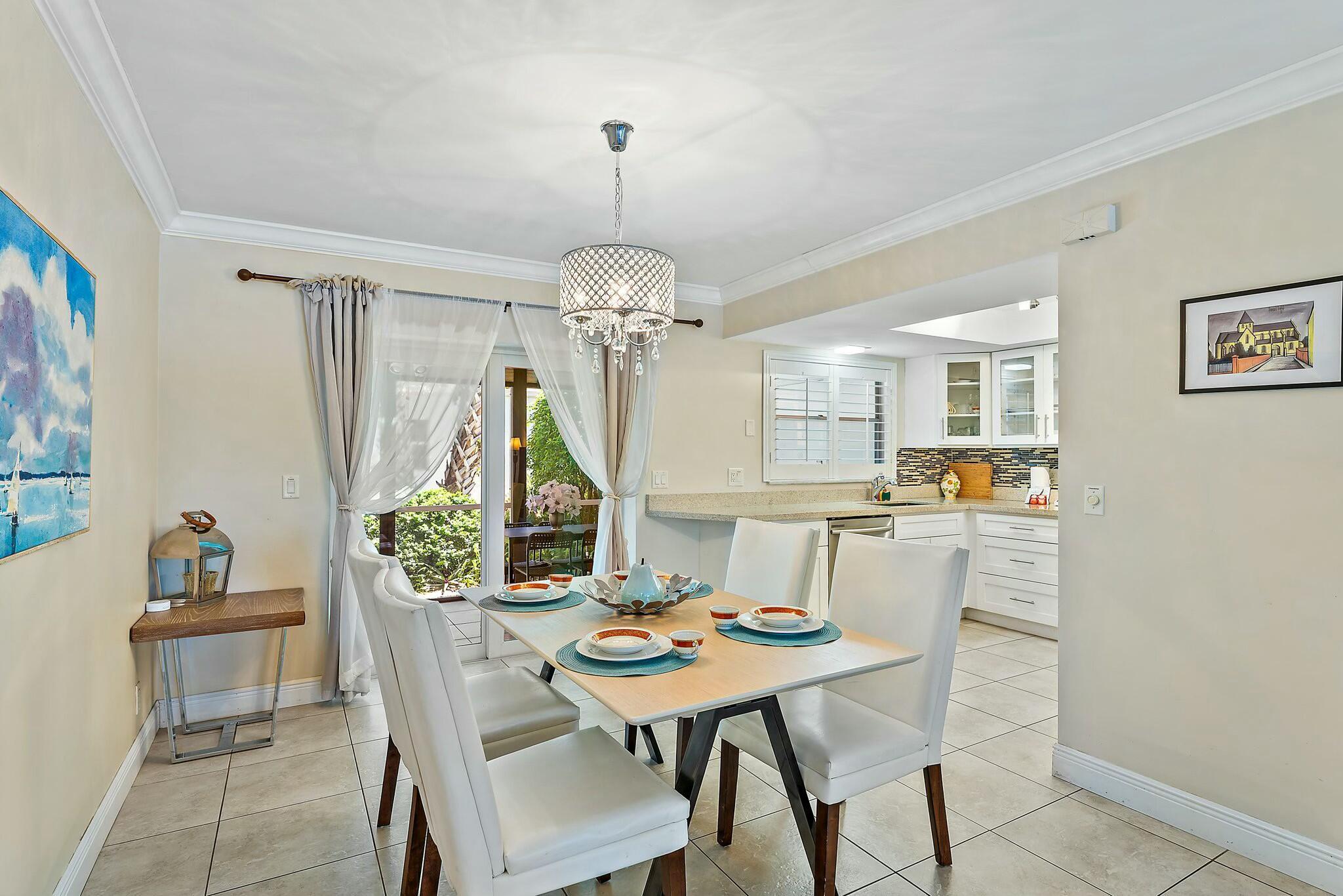 3036 Park Avenue Riviera Beach, FL 33404 - Photo 6 of 22 a view of a dining room with furniture window and wooden floor