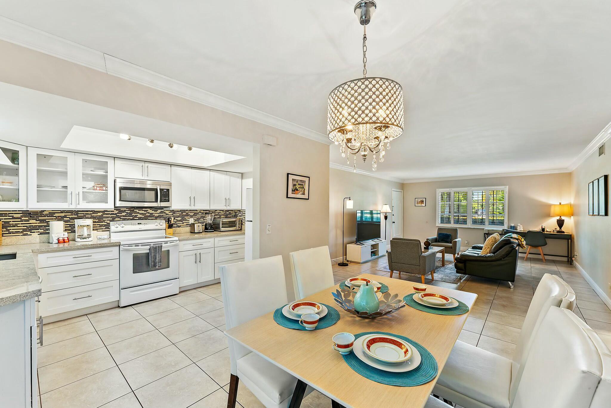 3036 Park Avenue Riviera Beach, FL 33404 - Photo 7 of 22 a open dining room with furniture kitchen view and wooden floor