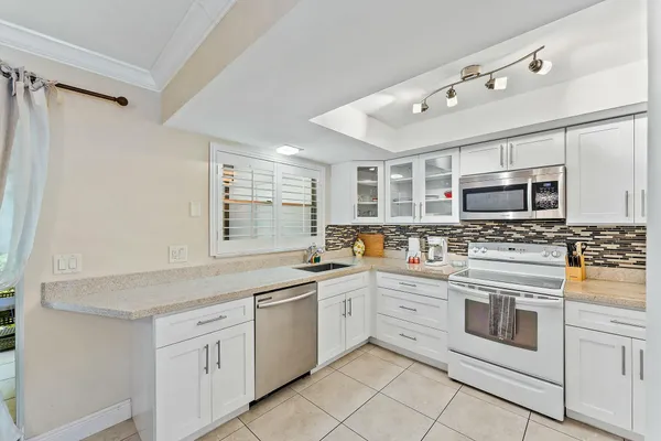 a kitchen with stainless steel appliances granite countertop a stove and a sink