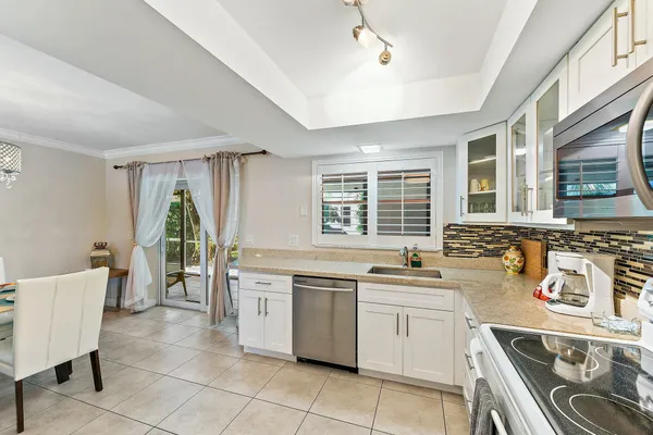 a kitchen with a sink stove and cabinets
