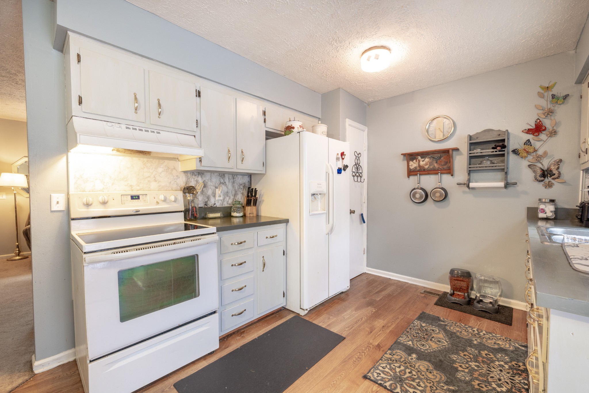 5622 Hopewell Road Springfield, TN 37172 - Photo 7 of 23 a kitchen with a refrigerator and white cabinets