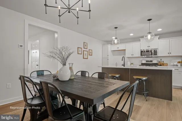 a view of a dining room and livingroom with furniture window and wooden floor