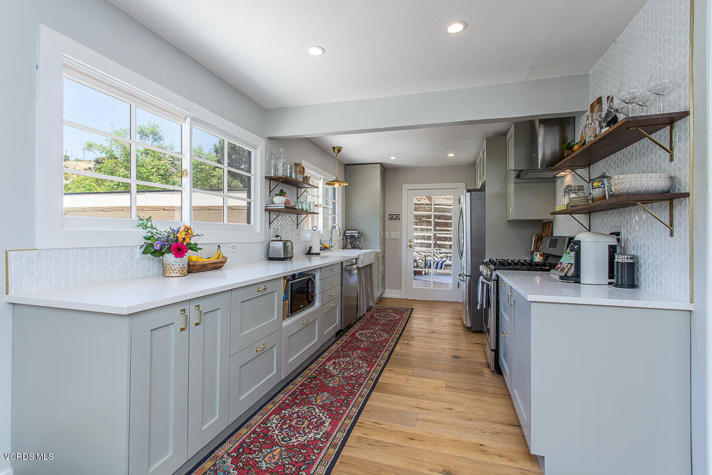 993 Katherine Road Simi Valley, CA 93063 - Photo 13 of 44 a large white kitchen with lots of counter space and a sink