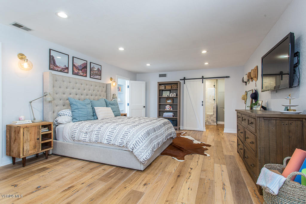 993 Katherine Road Simi Valley, CA 93063 - Photo 17 of 44 a spacious bedroom with a bed and a flat screen tv