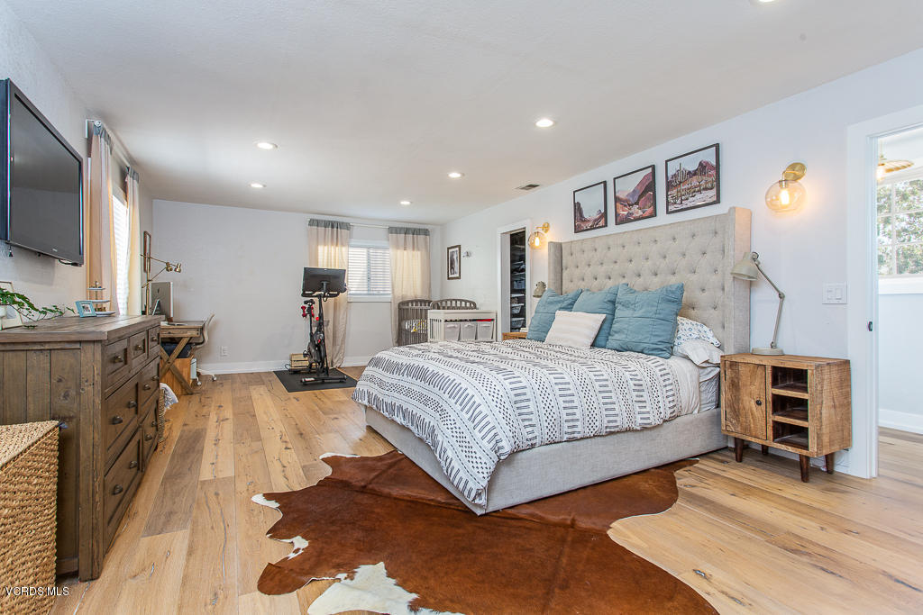 993 Katherine Road Simi Valley, CA 93063 - Photo 18 of 44 a spacious bedroom with a bed and a flat screen tv