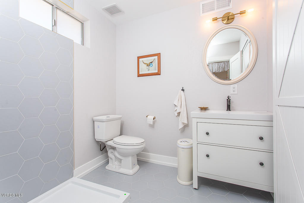 993 Katherine Road Simi Valley, CA 93063 - Photo 23 of 44 a bathroom with a toilet sink vanity and mirror