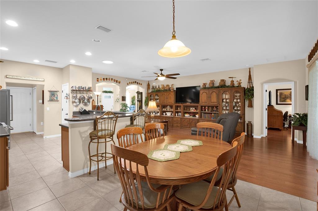 16411 Southwest 14th Avenue Road Ocala, FL 34473 - Photo 26 of 59 a dining room with stainless steel appliances granite countertop a dining table chairs and a refrigerator