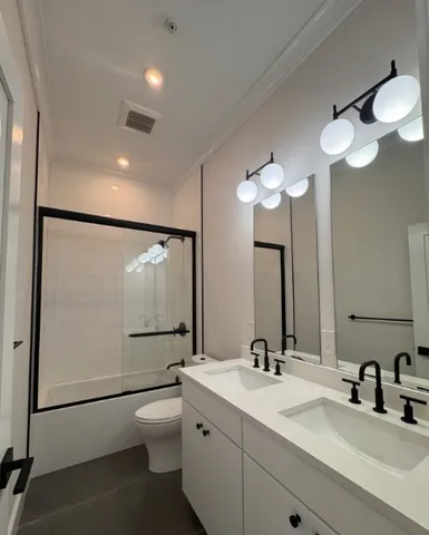 a bathroom with a toilet a sink and mirror
