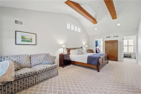 a kitchen with stainless steel appliances a refrigerator a sink cabinets and wooden floor
