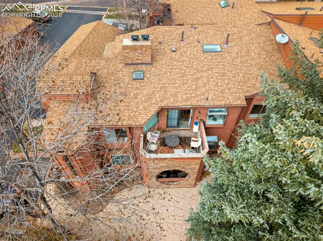 an aerial view of a house with a yard