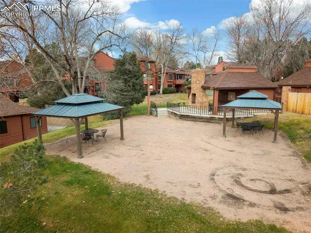 a backyard of a house with table and chairs