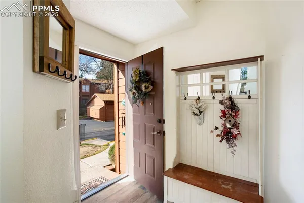 walk in closet with window and glass door