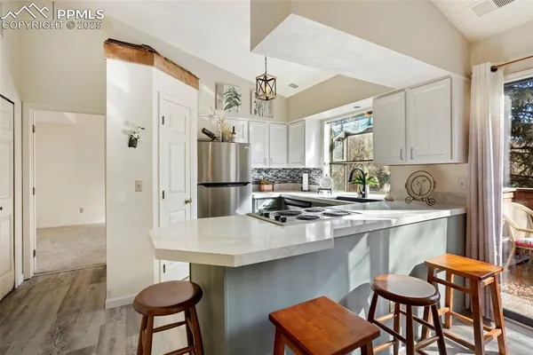 a kitchen with stainless steel appliances a sink and a refrigerator