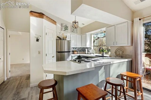 a kitchen with stainless steel appliances a sink and a refrigerator