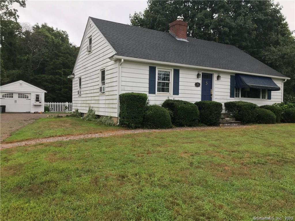 39 Masons Island Road Stonington, CT 06355 - Photo 16 of 16 a front view of a house with a garden