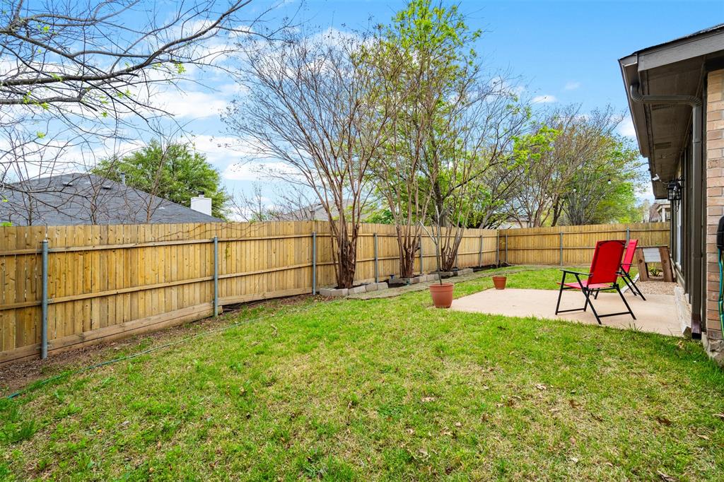 1011 Ridgecrest Drive McKinney, TX 75069 - Photo 27 of 31 Private backyard featuring a concrete patio, wood privacy fencing, and established trees