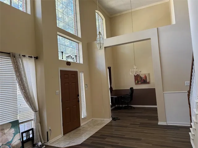 a view of a hallway with wooden floor and staircase