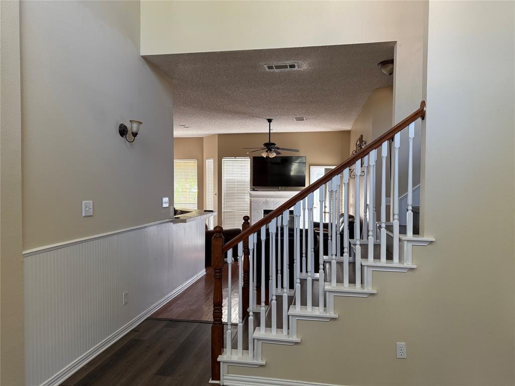 308 Santa Fe Trail Irving, TX 75063 - Photo 4 of 8 a view of staircase with wooden floor and fan