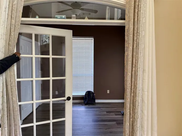 a view of a house with a large window and wooden floor