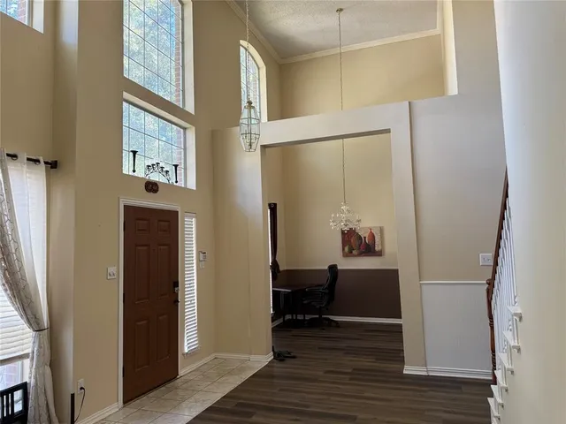 a view of a hallway with wooden floor and windows