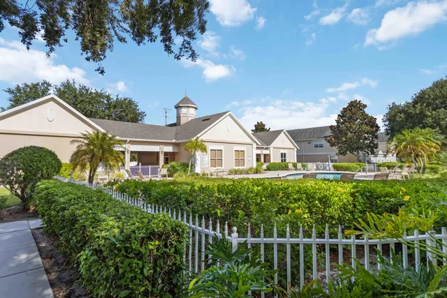a view of a swimming pool with a patio and a yard