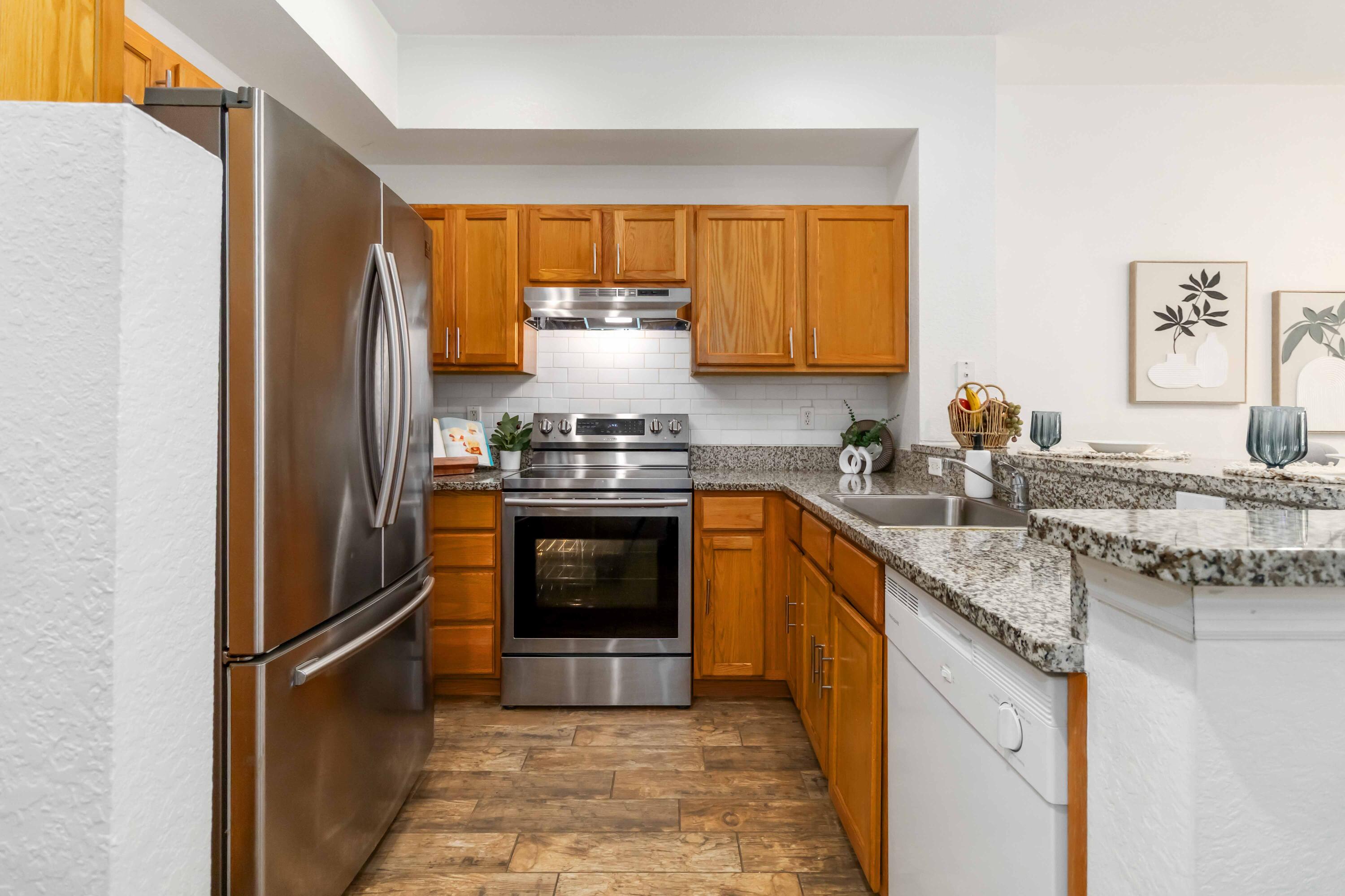 110 Turpial Way, Unit 102 Melbourne, FL 32901 - Photo 3 of 14 a kitchen with a sink stove and refrigerator