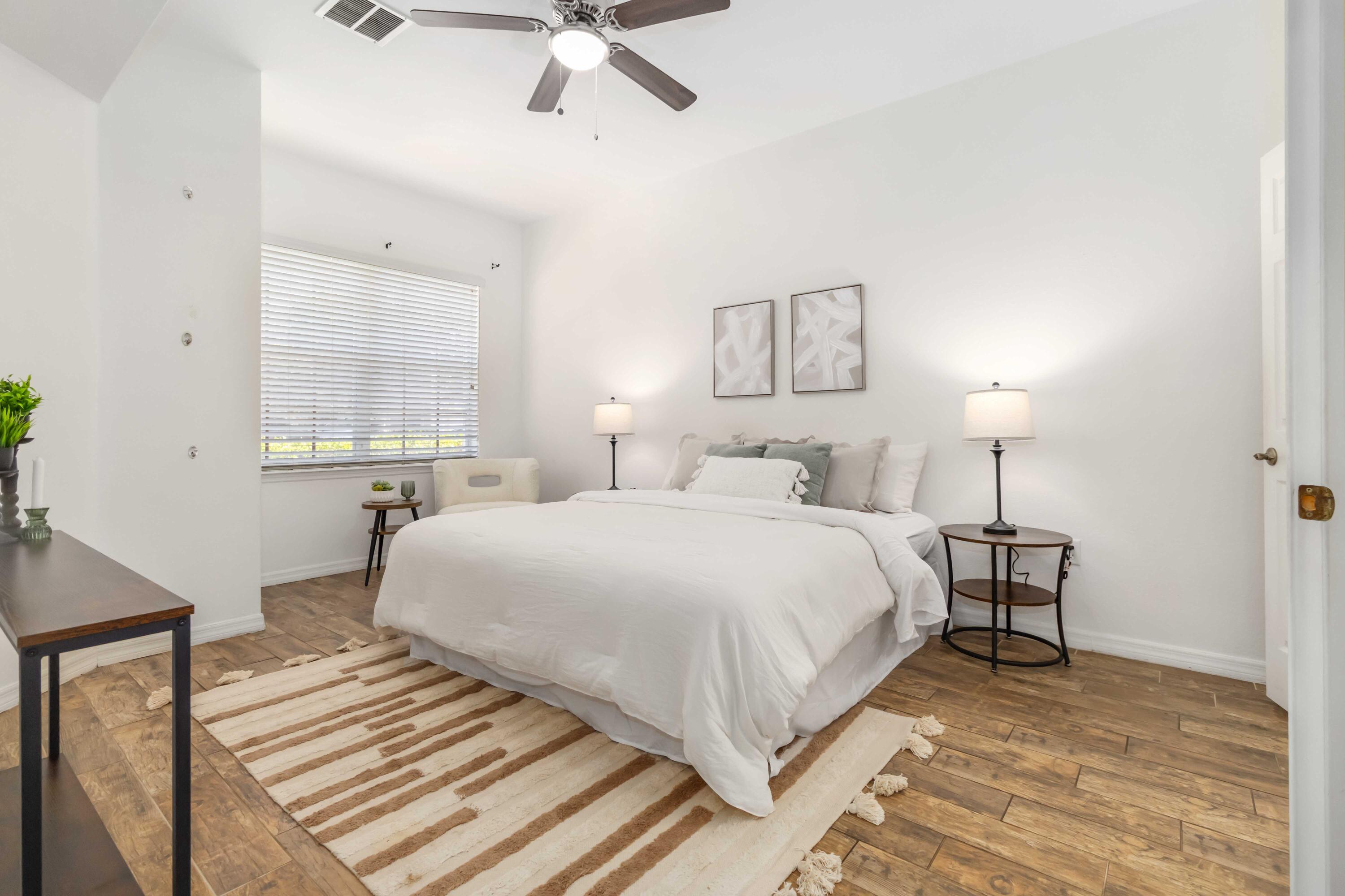 110 Turpial Way, Unit 102 Melbourne, FL 32901 - Photo 4 of 14 a bedroom with a bed and a night stand