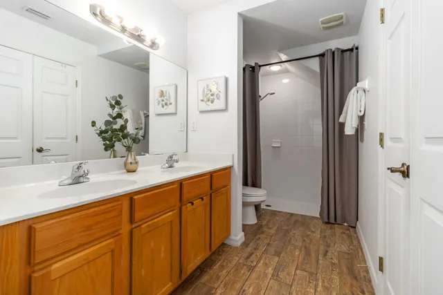 a bedroom with a bed and a night stand