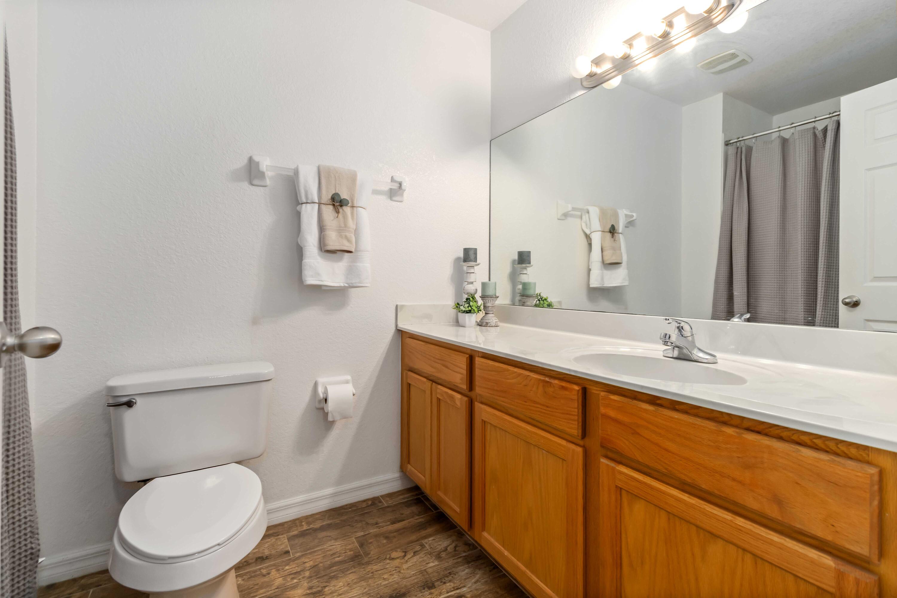110 Turpial Way, Unit 102 Melbourne, FL 32901 - Photo 8 of 14 a bathroom with a toilet a sink and mirror
