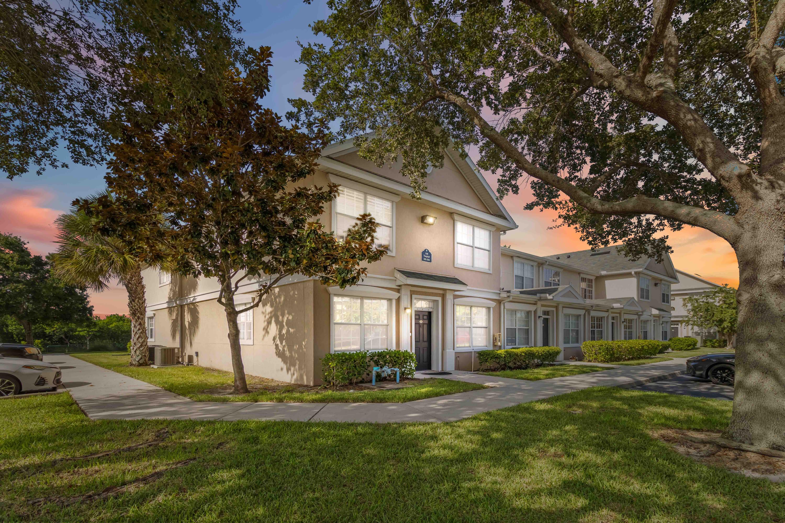 110 Turpial Way, Unit 102 Melbourne, FL 32901 - Photo 9 of 14 a front view of a house with a yard