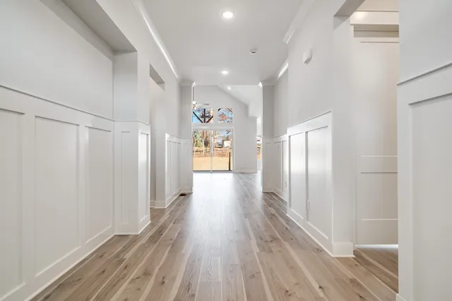 a view of a hallway with wooden floor