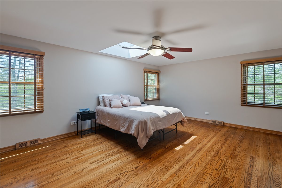 33 Half Day Road Lincolnshire, IL 60069 - Photo 11 of 38 a spacious bedroom with a bed and wooden floor