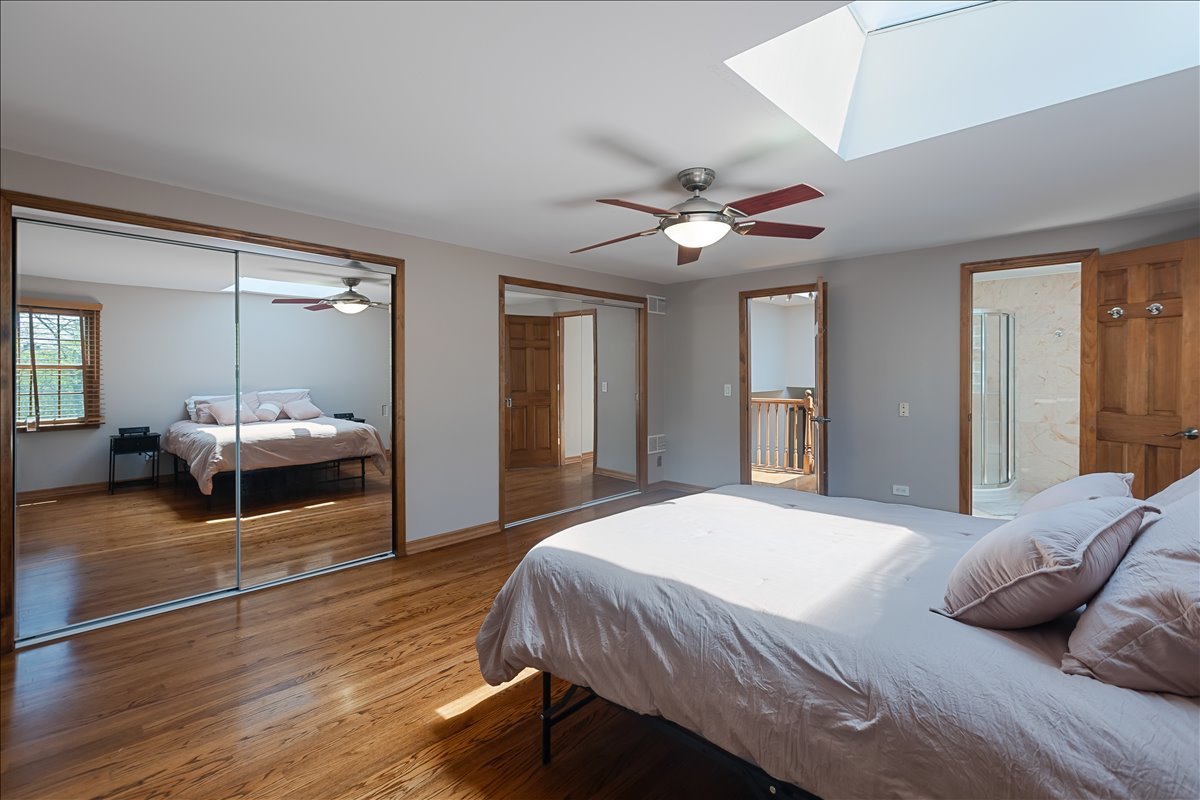 33 Half Day Road Lincolnshire, IL 60069 - Photo 12 of 38 a bedroom with a bed and a chandelier