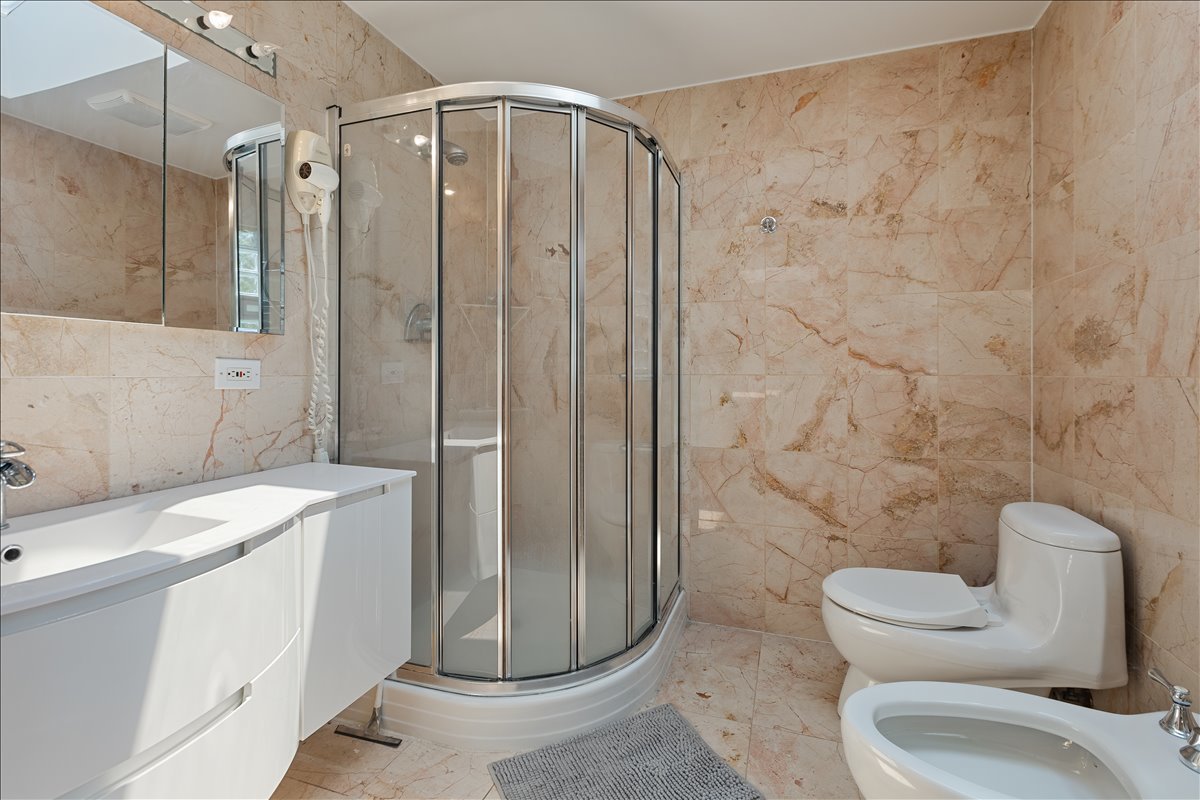 33 Half Day Road Lincolnshire, IL 60069 - Photo 13 of 38 a bathroom with a granite countertop sink toilet and shower