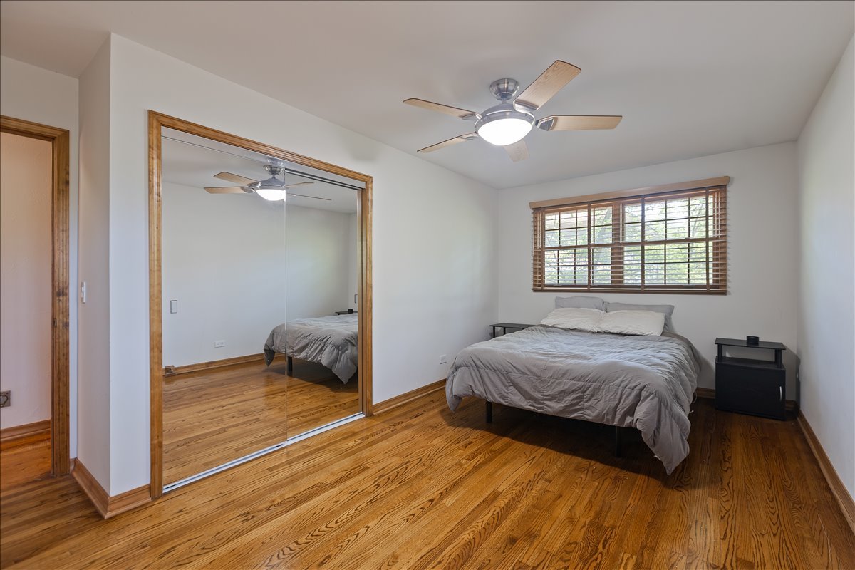 33 Half Day Road Lincolnshire, IL 60069 - Photo 17 of 38 a bedroom with a bed and a chandelier