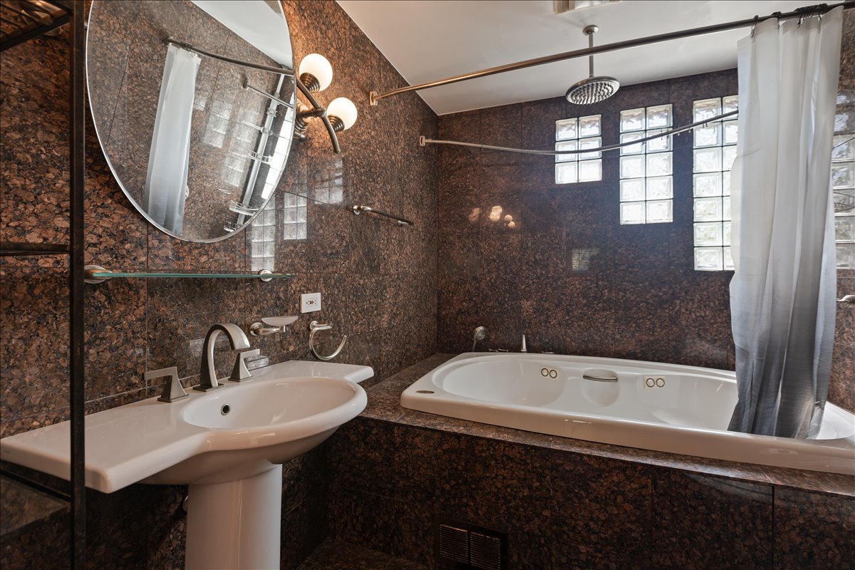 33 Half Day Road Lincolnshire, IL 60069 - Photo 18 of 38 a bathroom with a sink and a mirror