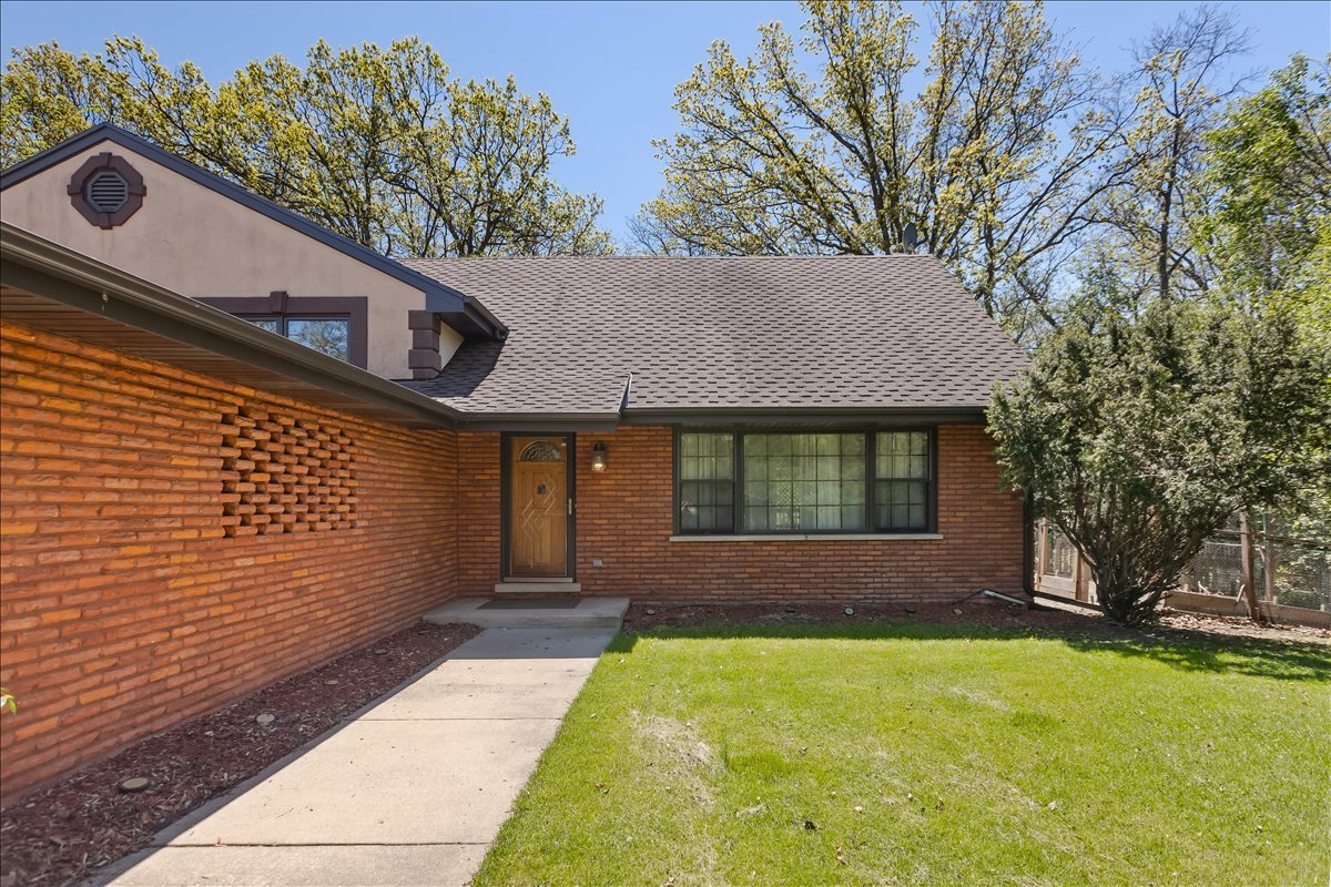 33 Half Day Road Lincolnshire, IL 60069 - Photo 2 of 38 a front view of a house with a yard and garage
