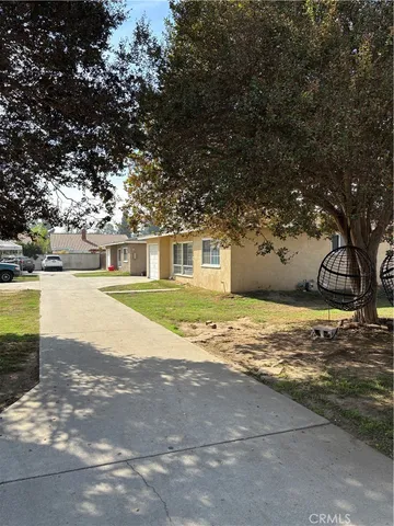 a view of big yard with large trees